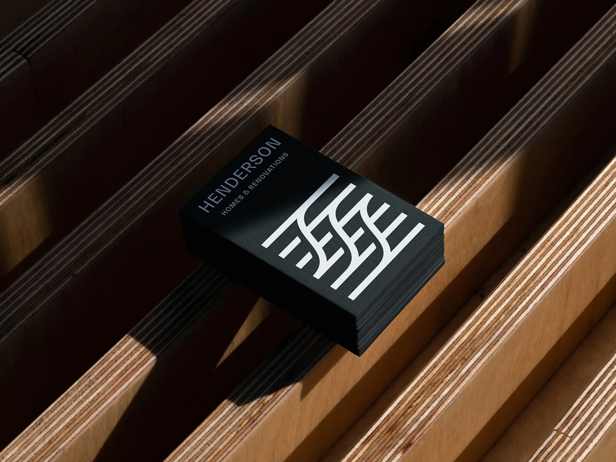 Henderson Homes business cards on timber battens.